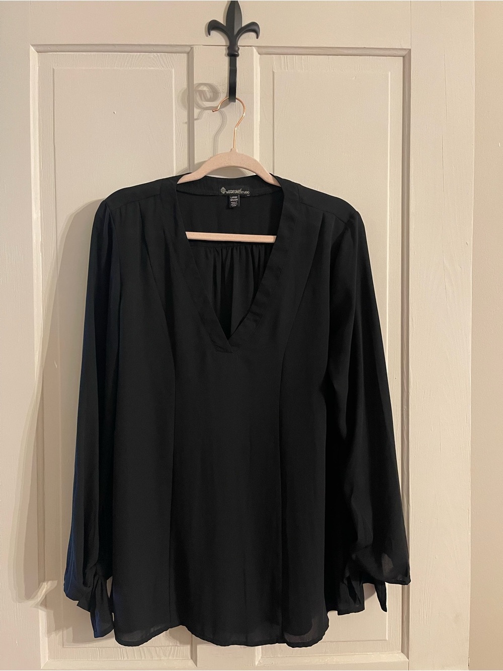 Elegant black blouse with ties at the wrists